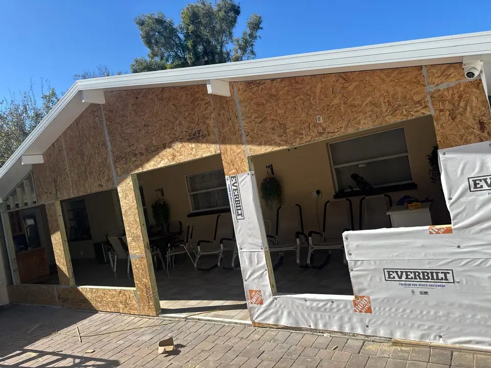 Residential patio being framed and enclosed with new windows and doors