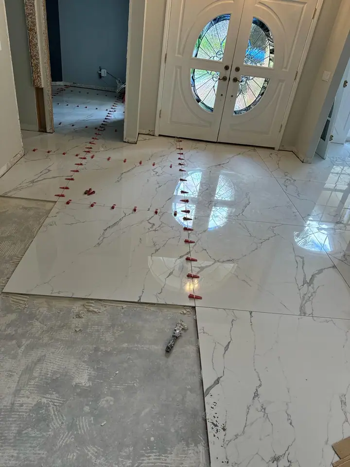 High-gloss large-format marble-look porcelain floors in a living space