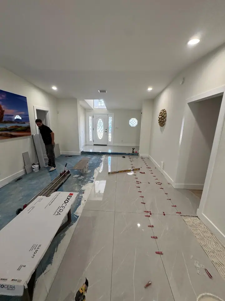 High-gloss large-format marble-look porcelain floors in a living space