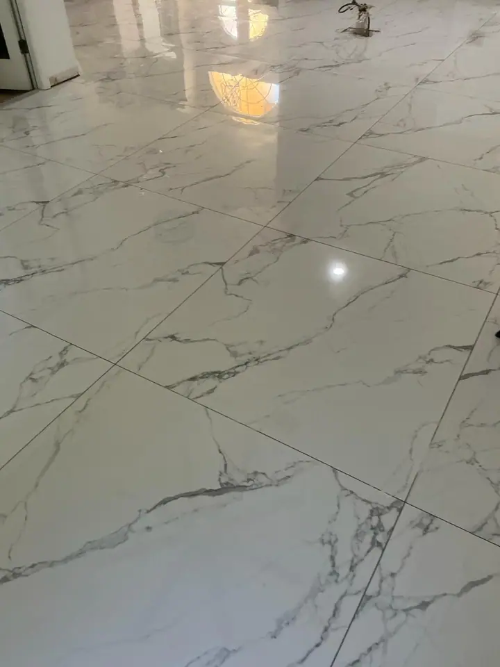 High-gloss large-format marble-look porcelain floors in a living space