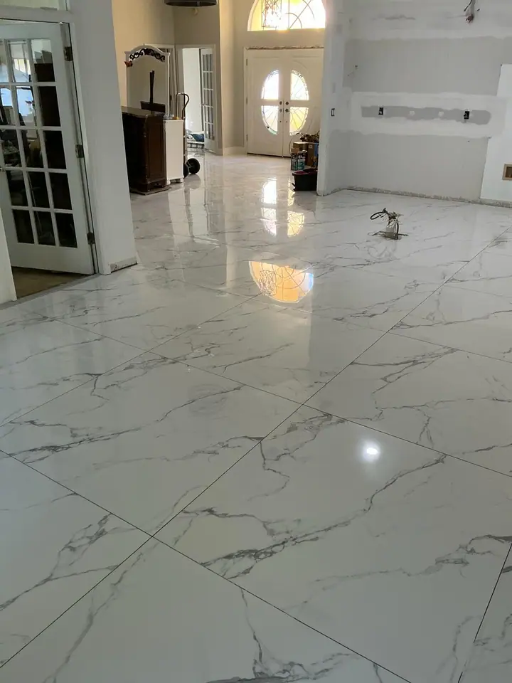 High-gloss large-format marble-look porcelain floors in a living space