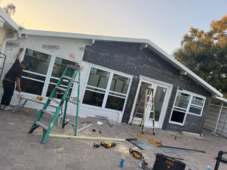 Residential patio being framed and enclosed with new windows and doors