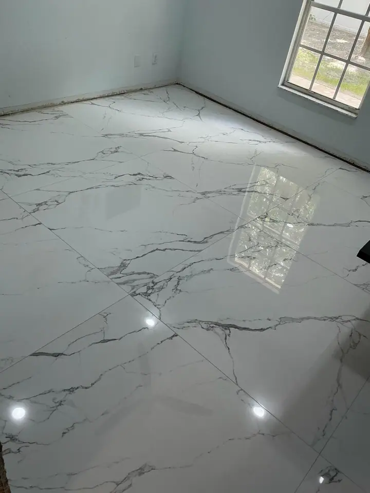 High-gloss large-format marble-look porcelain floors in a living space