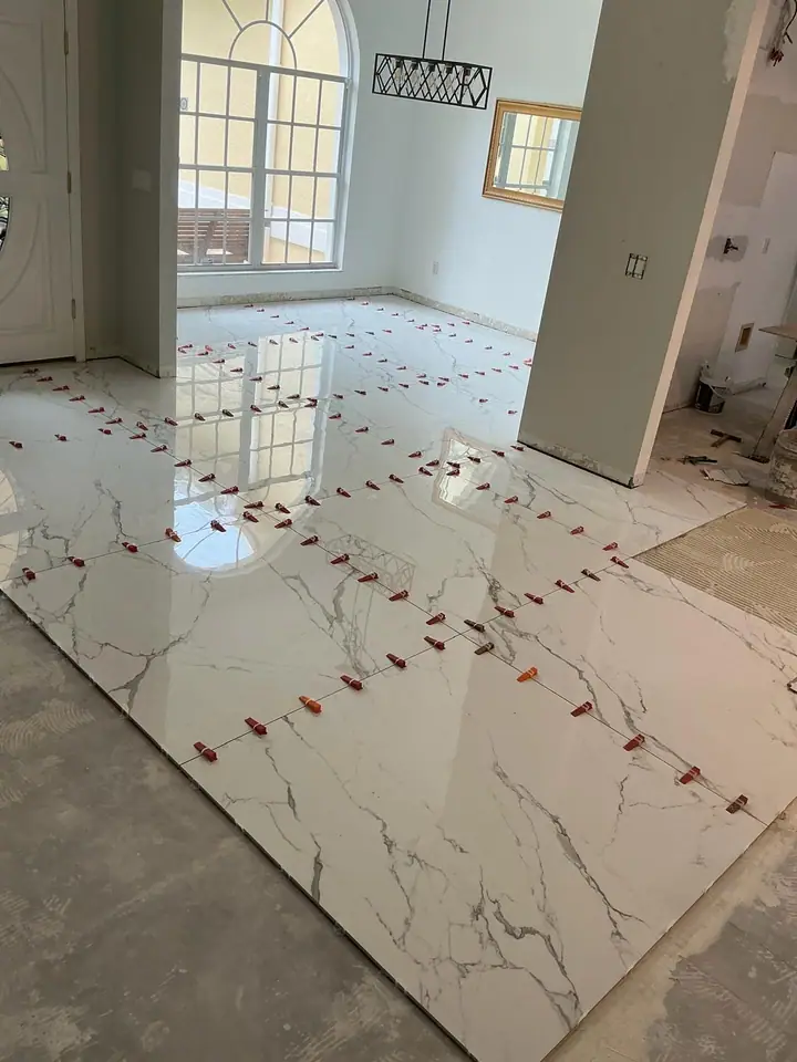 High-gloss large-format marble-look porcelain floors in a living space