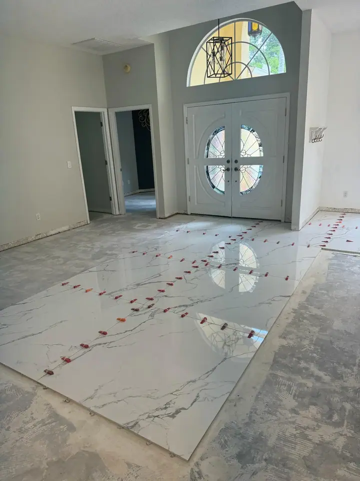 High-gloss large-format marble-look porcelain floors in a living space