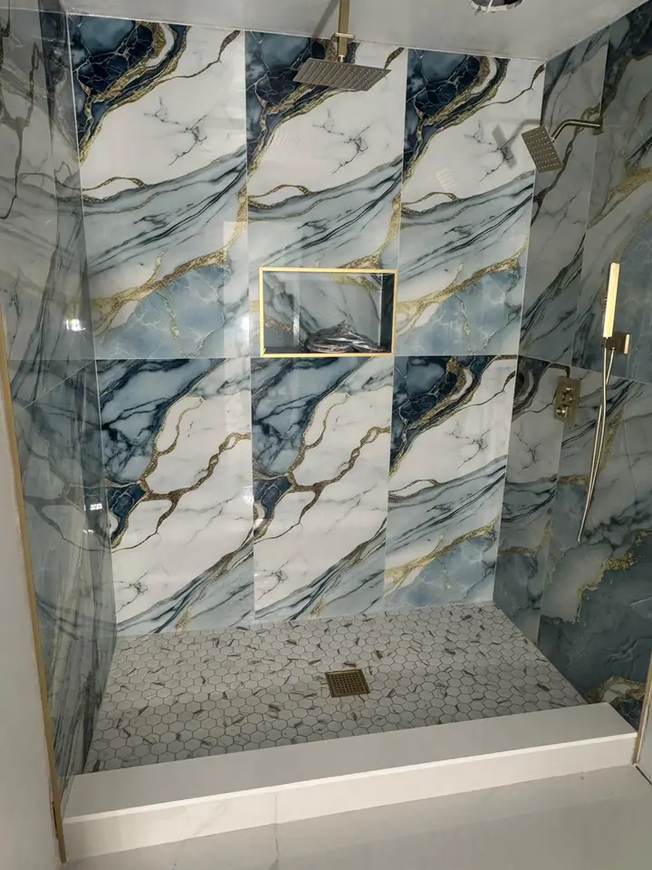 Walk-in shower with blue-veined marble porcelain and gold hardware