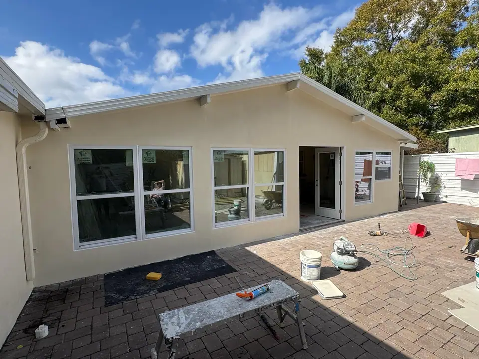 Residential patio being framed and enclosed with new windows and doors