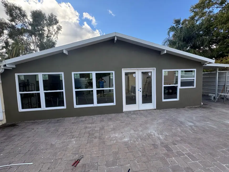 Residential patio being framed and enclosed with new windows and doors